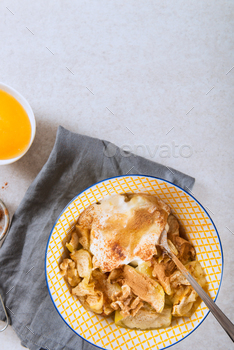topped with walnuts, coconut yogurt and honey, grey background, top view