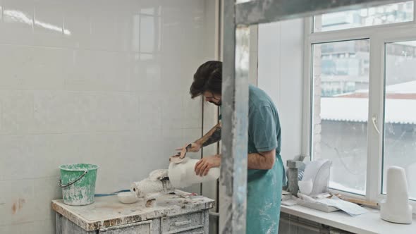 Bearded Man Polishing Detail In Workshop