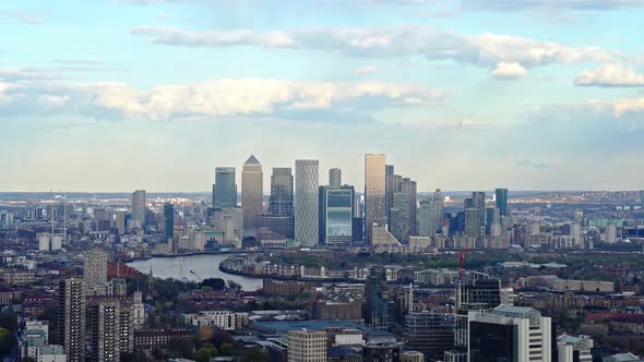 Aerial Wide shot showing Canary Wharf skyline during sunny day in London.