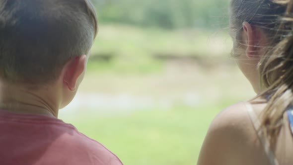 Brother and sister chatting outdoors