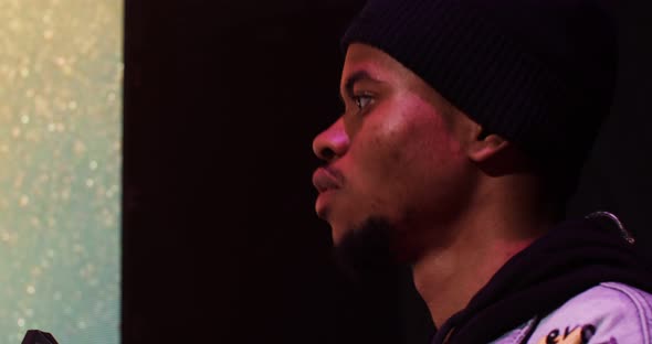 AfricanAmerican Man Dances While Playing an Electric Piano During a Concert