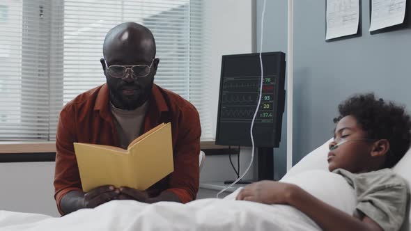 Man Reading to Son in Hospital