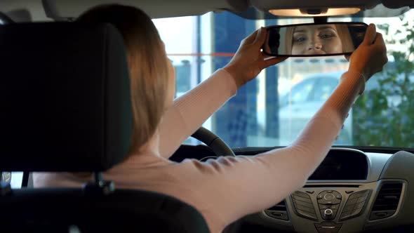 Girl Looks Into the Rear-view Mirror