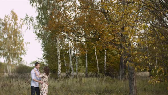 Young Couple Walking on a Meadow