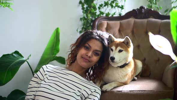 Woman Smiling and Taking Selfie Photo with Dog at Home Interior Spbd