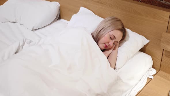 Woman Sleeping in Bed at Night on Side Top View