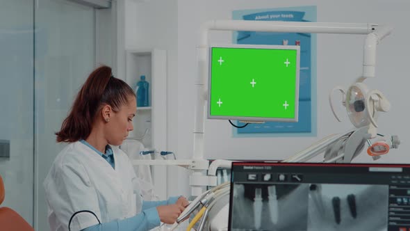 Woman Working As Dentist with Green Screen and x Ray Scan