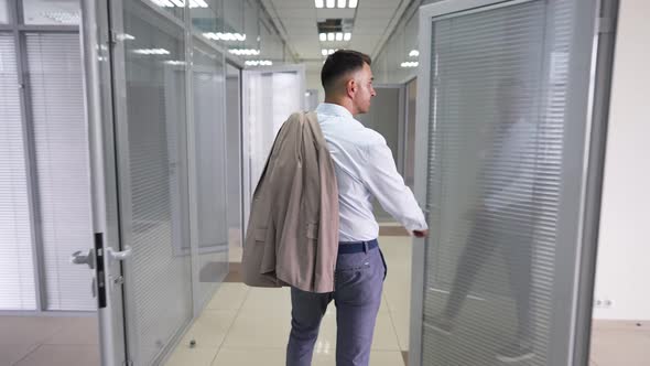 Live Camera Follows Positive Successful Man Walking in Office Corridor Waving Greeting Colleagues