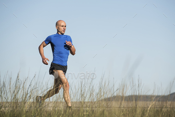 Man running along a grassy path
