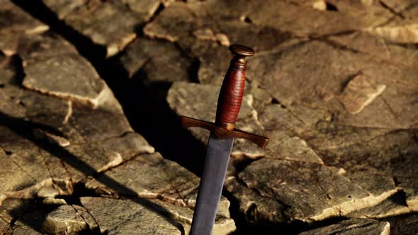 Excalibur Sword in Rocky Stone at Sunset