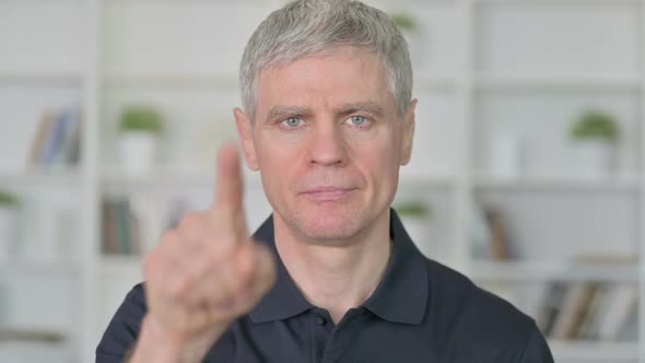 Cheerful Middle Aged Businessman Pointing Finger