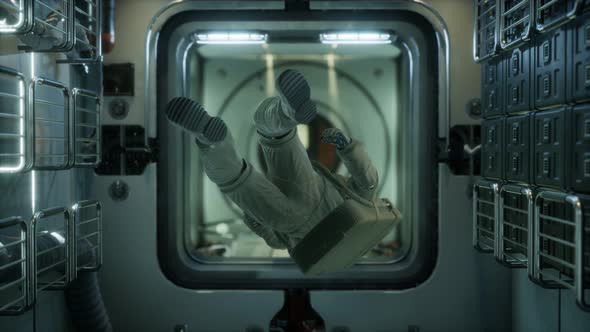 Astronaut Inside the Orbital Space Station alt