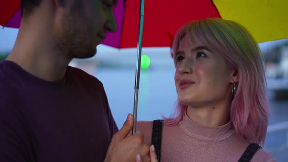 Closeup Charming Millennial Girlfriend Smiling Talking with Boyfriend Holding Colorful Umbrella