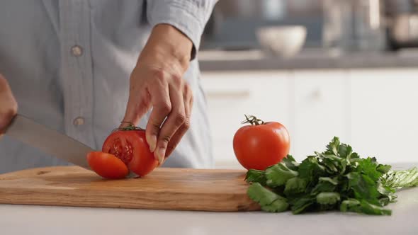 Close Up Footage of Female's Hands Accurately Slicing Tomatoes to Make Salad in Slowmotion