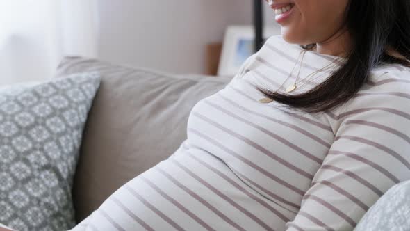 Happy Pregnant Asian Woman with Laptop at Home