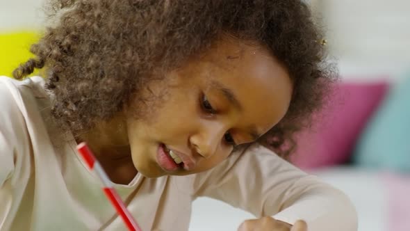Cute African Girl Drawing with Colored Pencil alt