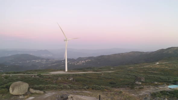 Casa do Penedo drone aerial view in Fafe with wind turbine, Portugal