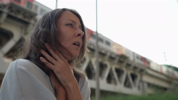 Portrait of a Brunette Under a Railway Bridge