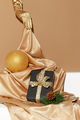 Hand in golden gloves holding chocolate cookies mix plate. - PhotoDune Item for Sale