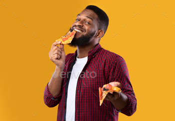 r Yellow Studio Background. Junk Food Overeating. Fastfood Eater Biting Slice Of Unhealthy Pizza. Nutrition And Binge Eating Habit Concept