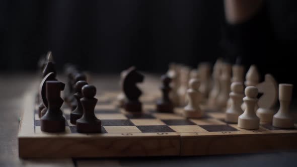 Closeup Tracking Shot of Unrecognizable Chess Player Performing Move with Pawn Piece on Chessboard