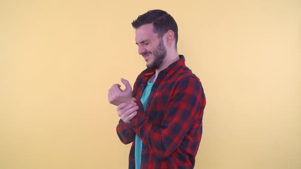 Man Holding His Wrist and Suffering Pain in Hand