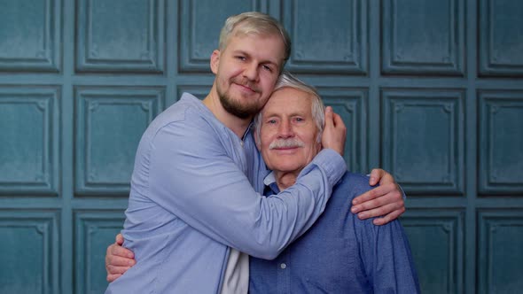 Happy Excited Young Man Embracing Grayhaired Old Dad or Grandfather Male Generations Family