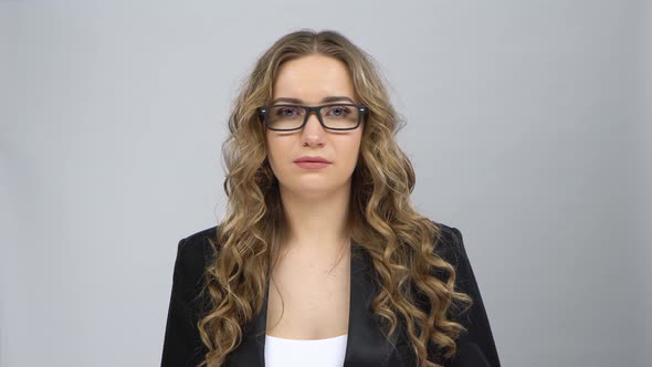 Woman in Business Suit Is Upset and Tired, Takes Off Her Glasses