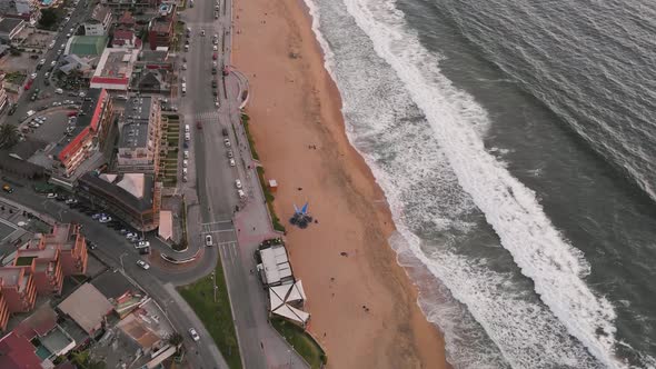 Aerial view over Renaca beach at sunset with buildings and cars in the background