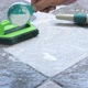human hand pours detergent onto the wet tile floor to clean it. - VideoHive Item for Sale