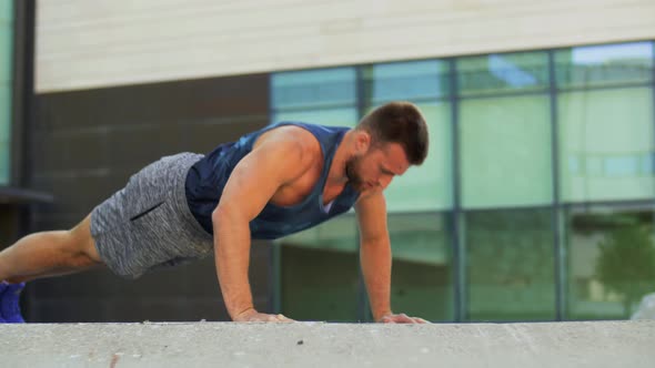 Young Man Doing Push Ups on City Street