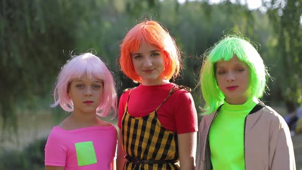 Teenage Girl Hugs Them Dressed in Colorful Wigs