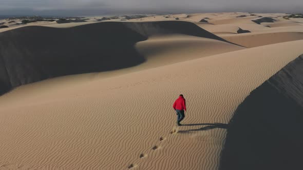 Running Man Workout Outdoors in Deep Sand Dunes  Aerial Desert Sport Footage