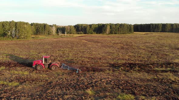 Red Tractor Ploughing Field