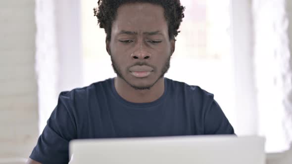 Ambitious African Man Celebrating Success of Online Project