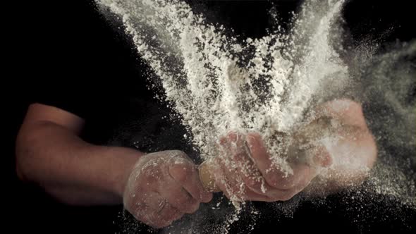 Super Slow Motion Men's Hands with Rolling Pin with Flour Sprays