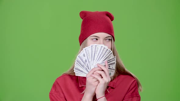 Teen Is Holding Paper Money in Her Hands. Green Screen. Slow Motion