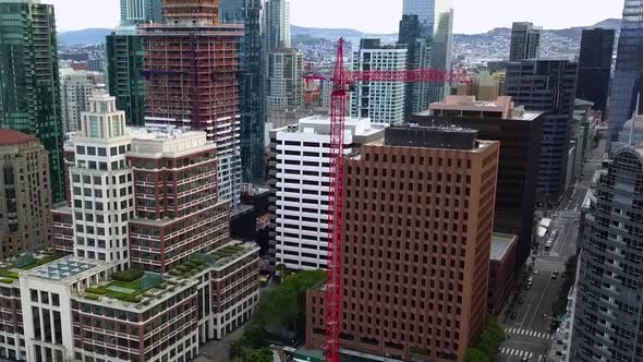 Aerial view around a construction crane, in San Francisco, USA - circling, drone shot