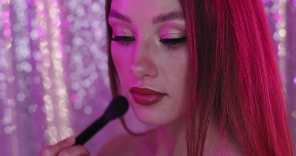 Glamour Girl with Perfect Makeup in Pink Light