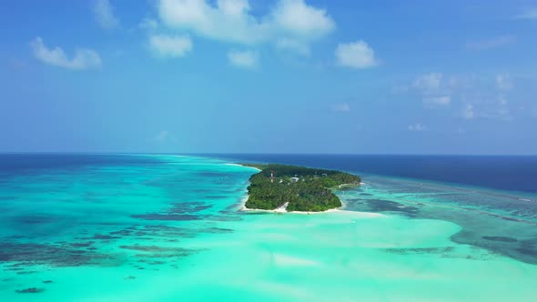 Wide angle above island view of a summer white paradise sand beach and aqua turquoise water