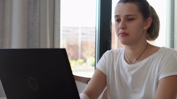 Authentic Caucasian Young Woman Chatting On Laptop At Home In Living Room