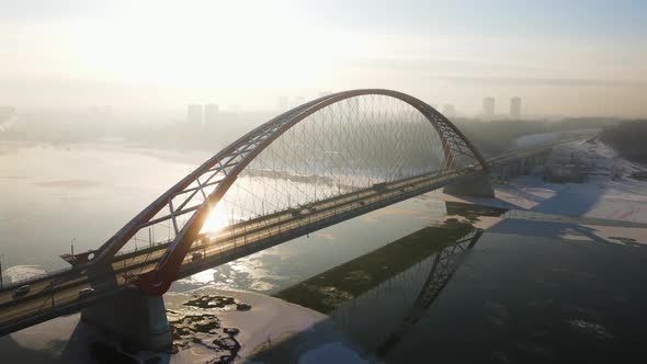 Bugrinsky Bridge Against the Backdrop of the Setting Sun and Light Haze