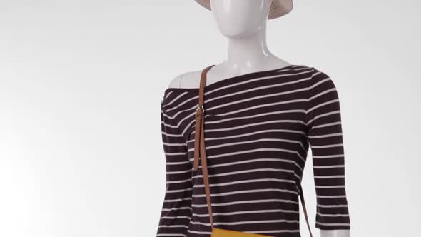 Female Mannequin Wearing Striped Top.