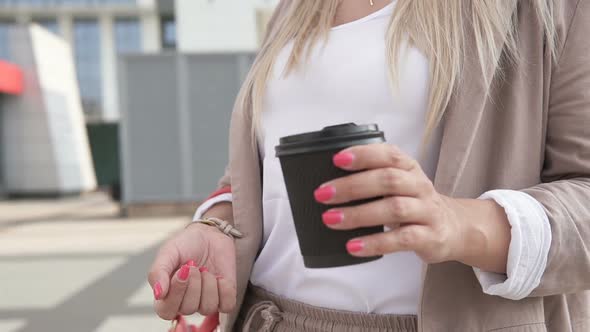 Business girl at a coffee break in a big city.