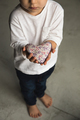 Baby boy hands giving toy heart. - PhotoDune Item for Sale