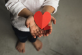 Two baby hands holding red paper hearts. - PhotoDune Item for Sale