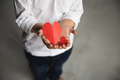 Two baby hands holding red paper hearts. - PhotoDune Item for Sale