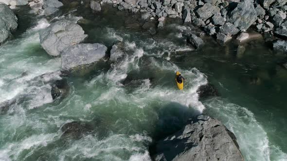 Drone Filming Kayaking In River Rapid Boulders