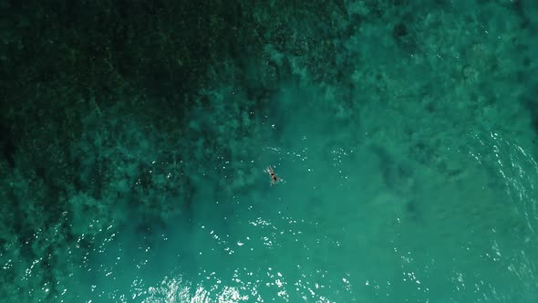 Young Woman Swimming in Beautiful Azure Ocean