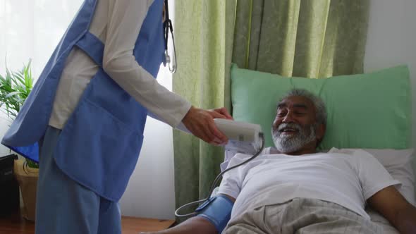 Nurse helping a senior man in retirement house